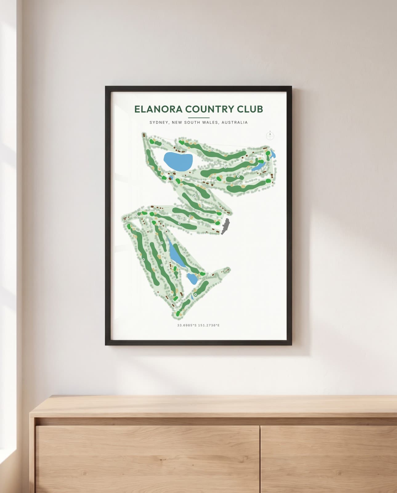 An Elanora Country Club print in a black frame, hanging above a sideboard